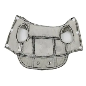 Detailed view of a light grey distressed denim vest for pets with snap buttons