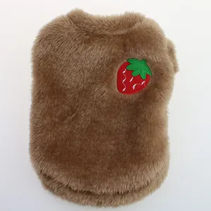 Close-up macro of brown plush pet clothing with a cute red strawberry embroidery.