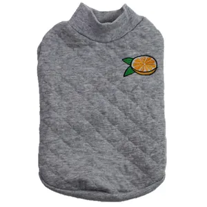 Detail view of a grey quilted dog shirt featuring a cute orange embroidery patch