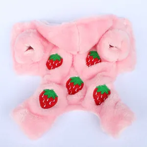 Close-up of pink plush pet clothes with vibrant strawberry embroidery details