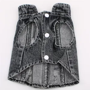 Macro view of black distressed denim pet vest featuring white buttons and ripped detail