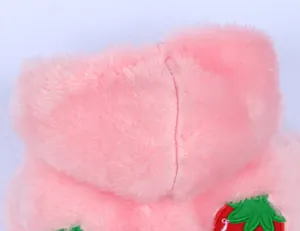 Close-up detail of pink plush pet hoodie featuring strawberry embroidery and soft texture