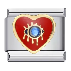 Macro detail of stainless steel heart charm with red enamel and blue evil eye design