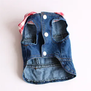 Detailed view of blue denim pet vest with red plaid hood and white snap buttons