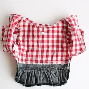 Close-up detail of a charming red checkered dog dress featuring a denim ruffle skirt.