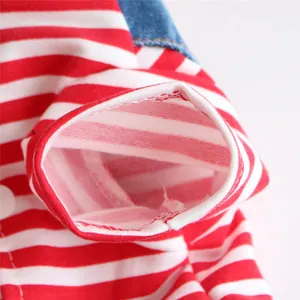 Macro detail showing the red and white striped sleeve on the pet denim dress garment