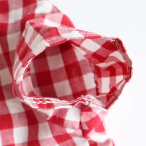 Close-up detail of red and white checkered pet clothing sleeve showing durable stitching