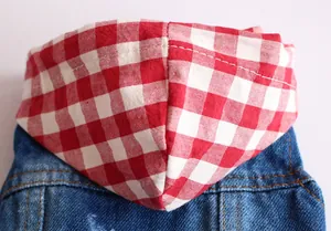 Close-up of pet denim vest featuring a stylish red checkered hood and fine stitching