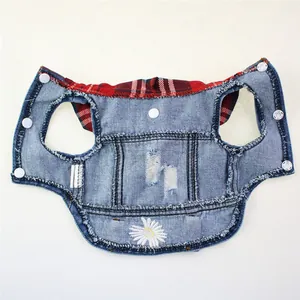 Detailed view of a denim dog vest featuring a plaid hood and white daisy embroidery.
