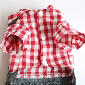 Close-up detail of red and white gingham pet shirt with white snap buttons and denim trim.