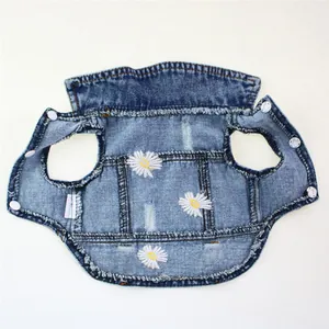 Detailed view of a daisy embroidered denim pet vest with trendy ripped design features