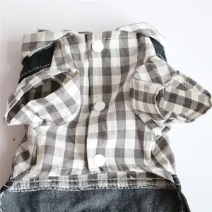 Close-up detail of checkered plaid and denim dog jumpsuit with white snap buttons