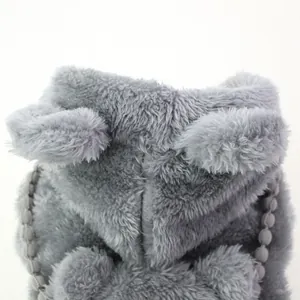 Close-up of grey plush pet hoodie with cute animal ears and pom-pom trim detail