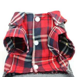Detailed view of red plaid pet onesie featuring white snap buttons and denim trims