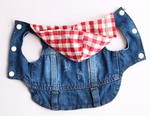 Detail of pet denim vest with red checkered hood lining and white snap buttons.
