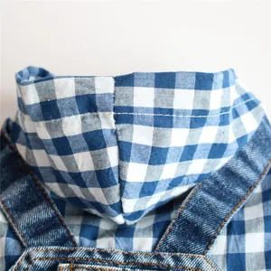 Detail shot showing the texture of blue gingham hood and denim fabric on pet dress