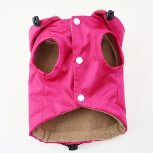Close-up detail of a pink waterproof pet jacket with warm brown fleece lining.