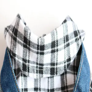 Detailed view of dog denim jacket featuring black and white plaid collar stitching