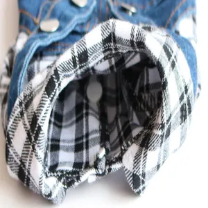 Close-up of dog jumpsuit showing denim fabric and soft plaid lining texture