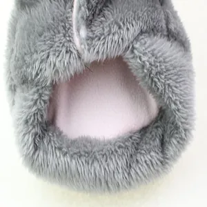 Close-up of thick plush pet clothing detail showing soft grey fur and pink fleece lining