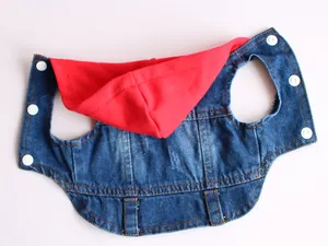 Detail of pet denim vest with red knit hood and white snap buttons