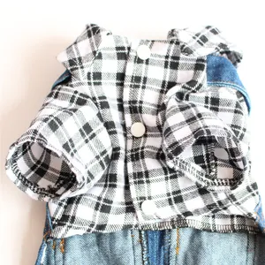 Detail of plaid shirt and denim dog overall clothes showing buttons and fabric texture