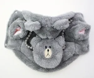 Detailed shot of a grey plush dog hoodie featuring bear face embroidery and 3D ears