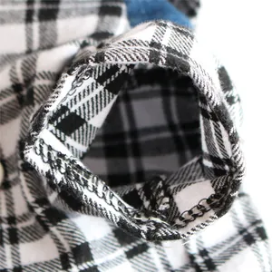 Detailed close-up view of a black and white plaid pet shirt sleeve with quality stitching