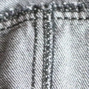 Macro view of high-quality denim fabric with sturdy double-row stitching for pet clothes