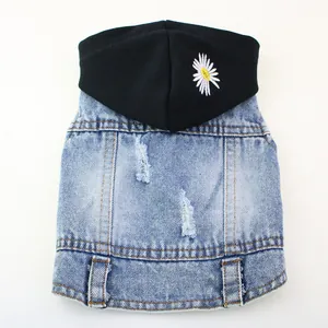 Close-up detail of pet denim vest featuring black hood and white daisy embroidery
