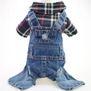 Macro view of pet denim jumpsuit showing the plaid shirt texture and ripped denim detail