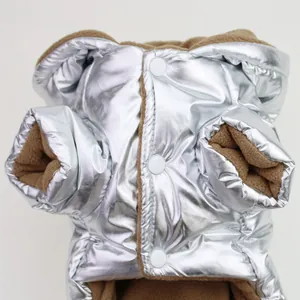 Close-up of silver metallic pet winter coat showing white snap buttons and fleece lining.