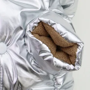 Close-up of thick brown fleece lining and silver metallic pet jacket fabric