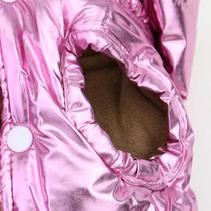 Close-up of metallic pink pet winter vest with soft fleece lining and snap button