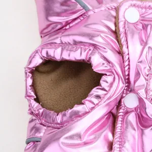Detail of shiny pink metallic pet vest with warm brown fleece lining and snap buttons