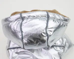 Macro detail showing metallic silver hooded pet coat with soft warm fleece lining for dogs
