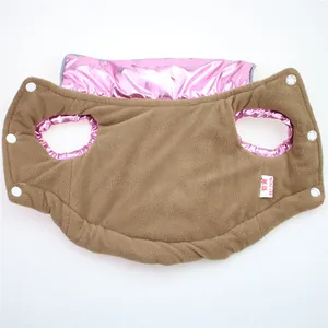 Close-up of the soft brown fleece lining and shiny pink exterior of a pet winter vest.