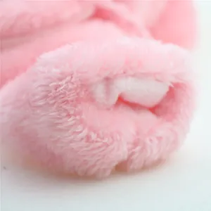 Macro view of pink plush dog coat material featuring a soft thickened fleece lining detail