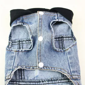 Close-up detail of blue pet denim vest featuring a black hood and white snap buttons