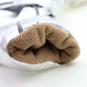 Close-up detail of silver metallic dog winter jacket with soft brown fleece lining