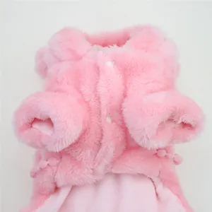 Detailed macro view of soft pink plush dog coat for winter with button closure
