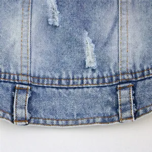 Close-up detail of distressed blue denim pet vest showing stitching and belt loops.