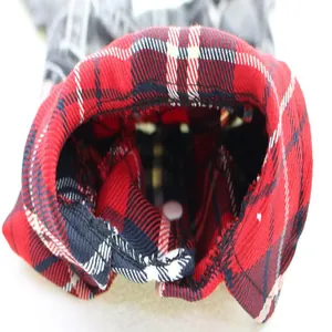 Detailed macro shot of red and navy plaid lining on denim dog jumpsuit for pets