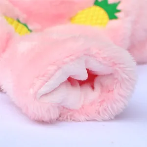 Detail view of pink fleece dog clothes with soft plush texture and pineapple pattern