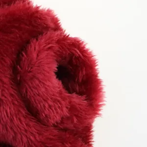 Detailed close-up of soft deep red plush fabric texture for small dog winter vest