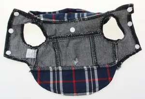 Detailed interior view of a pet dog vest featuring denim lining and navy plaid accents.