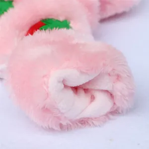 Macro detail of soft pink plush fabric and white velvet lining on dog coat.
