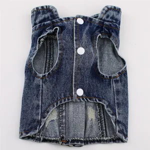 Close-up of blue denim pet vest featuring ripped textures and white snap buttons