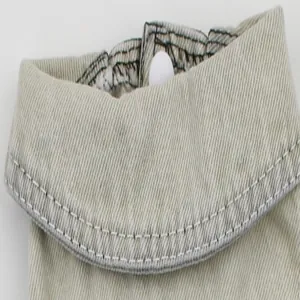 Close-up detail of pet denim vest collar with elastic neck and white stitching