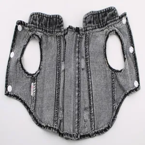 Detail view of distressed denim dog vest with white snap buttons